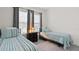 This bedroom offers two twin-sized beds, a nightstand, and windows providing plenty of natural light at 1925 Estuary Ln, Kissimmee, FL 34747