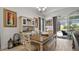 Charming dining room with wood table, slider access to pool area, and colorful art at 1925 Estuary Ln, Kissimmee, FL 34747