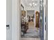 Elegant foyer featuring a decorative mirror, chandelier, and a view into the spacious living area at 1925 Estuary Ln, Kissimmee, FL 34747