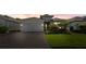 Inviting single-story home featuring a well-kept lawn and a convenient two-car garage with paver driveway at 1925 Estuary Ln, Kissimmee, FL 34747