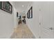 Long hallway featuring hardwood floors and modern white walls, leading to a brightly lit living area at 1925 Estuary Ln, Kissimmee, FL 34747