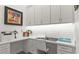 Bright home office featuring custom cabinetry, white subway tile, and modern decor at 1925 Estuary Ln, Kissimmee, FL 34747