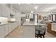 Spacious kitchen with stainless appliances, island with seating, and open view to the dining area at 1925 Estuary Ln, Kissimmee, FL 34747