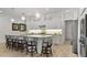 Bright kitchen boasts a large island with seating, stainless appliances, and stylish pendant lighting at 1925 Estuary Ln, Kissimmee, FL 34747