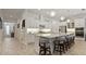 Beautiful kitchen features a large island, stainless appliances, modern lighting, and elegant white cabinetry at 1925 Estuary Ln, Kissimmee, FL 34747