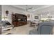 Cozy living room showcasing a large TV, built-in shelving, and comfortable seating at 1925 Estuary Ln, Kissimmee, FL 34747