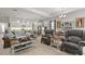 Bright, open-concept living room featuring hardwood floors, modern lighting, and a spacious layout at 1925 Estuary Ln, Kissimmee, FL 34747