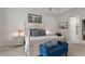 Bright main bedroom featuring a four-poster bed, plush seating, and soft, neutral decor at 1925 Estuary Ln, Kissimmee, FL 34747