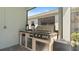 Built-in outdoor kitchen area with stainless steel grill and granite countertops, perfect for entertaining at 1925 Estuary Ln, Kissimmee, FL 34747