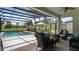 Inviting screened patio with fire pit, comfortable seating, and a seamless transition to the pool area at 1925 Estuary Ln, Kissimmee, FL 34747