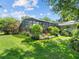 A lush backyard featuring a screened-in pool and plenty of greenery at 210 Lonesome Pine Dr, Longwood, FL 32779