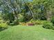 Expansive backyard boasting lush green grass and mature landscaping, providing a tranquil outdoor space at 210 Lonesome Pine Dr, Longwood, FL 32779