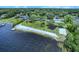 A lakeside beach with a playground, grassy area, and lake access on a clear sunny day at 210 Lonesome Pine Dr, Longwood, FL 32779