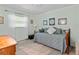 Cozy bedroom with a daybed, bright window, and warm wood floors at 210 Lonesome Pine Dr, Longwood, FL 32779