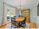 Formal dining room featuring a wooden table, ornate hutch, and a large window with natural light at 210 Lonesome Pine Dr, Longwood, FL 32779