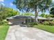 Charming one-story home with a two-car garage, manicured lawn, and mature trees offering shade and curb appeal at 210 Lonesome Pine Dr, Longwood, FL 32779