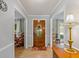Warm foyer with a decorative front door, tiled flooring, and views into adjacent living spaces at 210 Lonesome Pine Dr, Longwood, FL 32779