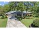 Attractive single-story home showcasing lush landscaping, mature trees, and a well-maintained front yard at 210 Lonesome Pine Dr, Longwood, FL 32779