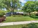 Charming single-story home featuring a well-manicured lawn, mature trees, and inviting curb appeal at 210 Lonesome Pine Dr, Longwood, FL 32779