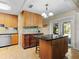 Well-appointed kitchen with wooden cabinets, granite counters, and views to the outdoors through French doors at 210 Lonesome Pine Dr, Longwood, FL 32779