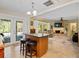 Open floor plan featuring a kitchen island and a living room with stone fireplace at 210 Lonesome Pine Dr, Longwood, FL 32779
