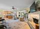 Bright living room with a stone fireplace, open to the kitchen and views of backyard at 210 Lonesome Pine Dr, Longwood, FL 32779