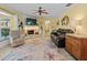 Cozy living room featuring a stone fireplace, comfortable seating, and stylish decor at 210 Lonesome Pine Dr, Longwood, FL 32779