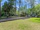 A view of a swing set and playground set in a park surrounded by trees at 210 Lonesome Pine Dr, Longwood, FL 32779