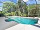 Screened-in pool with a beautiful water view and well-maintained concrete pool deck at 210 Lonesome Pine Dr, Longwood, FL 32779