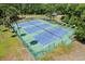 Aerial view of three tennis courts surrounded by a green fence and trees at 210 Lonesome Pine Dr, Longwood, FL 32779