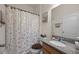 Cozy bathroom with a single vanity, granite countertop, and a shower with a decorative curtain at 2380 Kaley Ridge Rd, Clermont, FL 34715