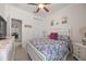 Comfortable bedroom with floral bedding, closet, and view into the home's dining area at 2380 Kaley Ridge Rd, Clermont, FL 34715