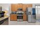 Well-equipped kitchen featuring wooden cabinets, stainless steel appliances, and granite countertops at 2380 Kaley Ridge Rd, Clermont, FL 34715