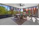 Relaxing screened lanai with outdoor seating, curtains, ceiling fan, and a view of nature at 2380 Kaley Ridge Rd, Clermont, FL 34715