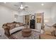 Comfortable living room features stylish furniture, a ceiling fan, and sliding glass doors to the lanai at 2380 Kaley Ridge Rd, Clermont, FL 34715