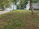 Exterior shot of two homes with green space between them and trash bins in view at 2507 Lafayette Ave, Winter Park, FL 32789