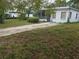 A single-story home with a front yard and a concrete driveway leading up to the screened-in porch at 2507 Lafayette Ave, Winter Park, FL 32789