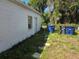 The side of the house with an exterior door, small window and trash bins along a stone path at 2507 Lafayette Ave, Winter Park, FL 32789
