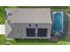Aerial view highlighting the home's roof, solar panels, and screened-in pool area for outdoor enjoyment at 2535 Oneida Loop, Kissimmee, FL 34747