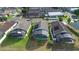 Backyard aerial view showcasing screened pools and solar panels on neighboring homes in a residential area at 2535 Oneida Loop, Kissimmee, FL 34747