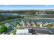 Aerial view featuring waterfront homes with a highway in the background showcasing a scenic residential community at 2535 Oneida Loop, Kissimmee, FL 34747