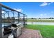 Outdoor backyard with a pool, grill, and picturesque water view at 2535 Oneida Loop, Kissimmee, FL 34747