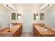 Bathroom vanity with double sinks, warm lighting, and tiled floors at 2535 Oneida Loop, Kissimmee, FL 34747