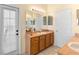 Bathroom with single vanity, warm lighting, and direct access to the outside at 2535 Oneida Loop, Kissimmee, FL 34747