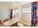 Bathroom featuring a Mickey Mouse shower curtain, bath and a modern sink at 2535 Oneida Loop, Kissimmee, FL 34747