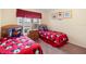 Bedroom with Mickey Mouse bedding, twin beds and neutral colored walls at 2535 Oneida Loop, Kissimmee, FL 34747