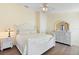 Bedroom with wood floors, a ceiling fan and a dresser with a large mirror at 2535 Oneida Loop, Kissimmee, FL 34747