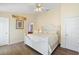 Bright bedroom featuring a white bed frame and ceiling fan at 2535 Oneida Loop, Kissimmee, FL 34747