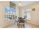 Cozy breakfast nook with a glass table and views of the enclosed patio and backyard at 2535 Oneida Loop, Kissimmee, FL 34747