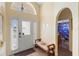 Inviting foyer with a decorative front door, sidelights and archway leading to the bathroom at 2535 Oneida Loop, Kissimmee, FL 34747